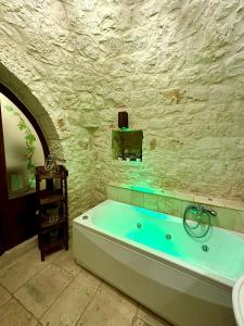 a bathroom with a bath tub in a stone wall at La Pergola in Locorotondo