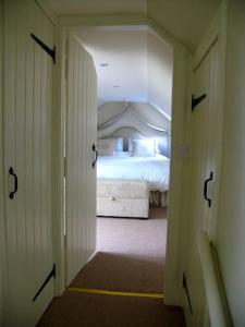 a hallway leading to a bedroom with a bed at Beautiful spacious old schoolhouse with stunning sea views and beach nearby in Port Bannatyne