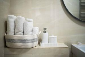 Baño con toallas en un estante con espejo en Superb Flat in South Kensington, en Londres