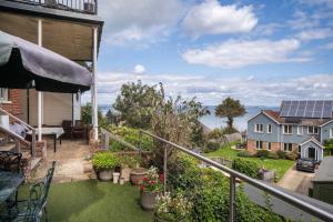 a balcony of a house with a view of the ocean at Flat 1, Baymount in Seaview