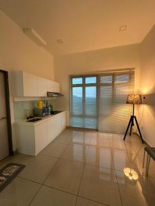 a kitchen with white cabinets and a lamp in it at Manhattan Austin 2-6 pax Family Cozy Suite in Johor Bahru