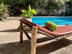 une chaise avec pastèque à côté de la piscine dans l'établissement Villa Kipara - Beachfront with Private Pool, à Pwani Mchangani