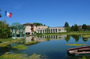 a building next to a lake with a gazebo at Hôtel du Bois Blanc Domaine d'Epeyssoles Georges Blanc in Vonnas +14 photos