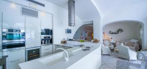 a kitchen with a sink and a living room at Villa Il Canto - Homelike Villas in Positano