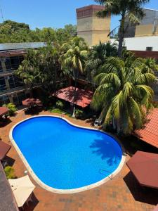 a large blue swimming pool on top of a building at Gran Hotel Paris in La Ceiba