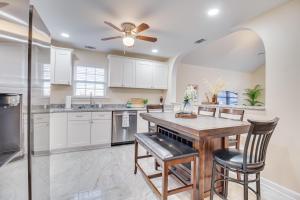 a kitchen with white cabinets and a table and chairs at Family Home Near Downtown and Convention Center! in Savannah