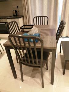 a dining room table and chairs with a table and a table and chairs at Hawana Forest Island - Simplex House in Salalah