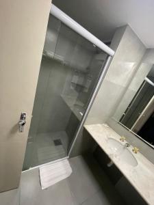 a bathroom with a glass shower and a sink at MIX APART Hotel in Brasília