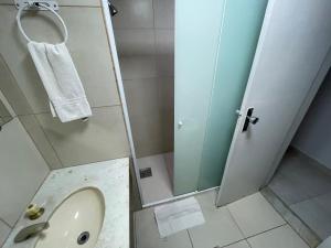 a bathroom with a shower with a sink and a toilet at MIX APART Hotel in Brasília