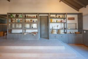 a room with blue cabinets and shelves with ceramics at La Posta de los Toldos in Perito Moreno