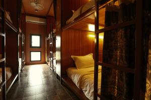 a bedroom with a bunk bed in a room at House Of Jars in Vientiane