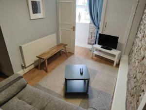 a living room with a couch and a coffee table at Kings Arms Hotel in Kirkby Lonsdale