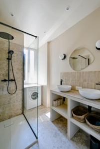 ein Bad mit einer Glasdusche und 2 Waschbecken in der Unterkunft Mytripinparis - Fully renovated 2 bedrooms in Neuilly-sur-Seine