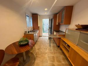 a kitchen with a wooden table and a counter top at Yoga House in Torre de Benagalbón