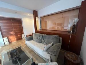 a living room with a couch and a glass table at Yoga House in Torre de Benagalbón