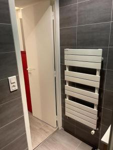 a bathroom with a walk in shower and a mirror at Mytripinparis - Sablons in Neuilly-sur-Seine