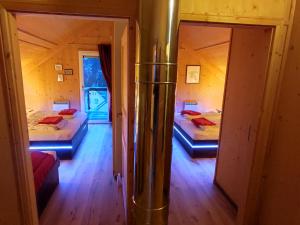 a room with two beds and a mirror at Panorama-Chalet Alpenglöckchen in Stadl an der Mur