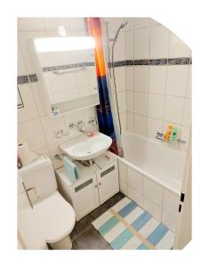 a small bathroom with a toilet and a sink at Ruhiges 2 Zimmer Apartment in Bern Zentrum in Bern