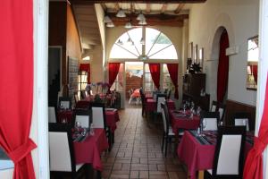 un restaurante con mesas rojas y sillas en una habitación en Terre de Brenne, en Azay-le-Ferron