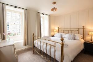 a bedroom with a large bed and a window at The Manor House in Port Isaac