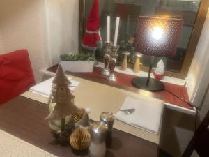 a desk with a lamp and christmas decorations on it at Harzhotel Warnstedter Krug in Thale