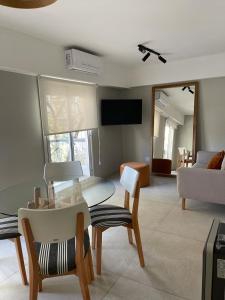 a living room with a table and chairs and a couch at Departamento Fabuloso 3 in Rosario