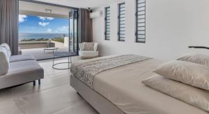 a bedroom with a bed and a view of the ocean at Villa Regatta in Kralendijk +21 photos