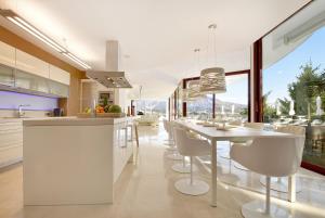 uma cozinha com mesa e cadeiras e uma grande janela em Villa White Nueva Andalucia em Marbella