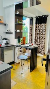 a kitchen with a table and chairs in a room at 8 Plus Motels in Negombo