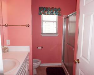 a bathroom with a toilet and a sink and a shower at Venture Out 402 North Marlin Dr WITH GOLF CART in Panama City Beach +17 photos