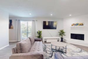 a living room with a couch and a fireplace at Entire 3/2.5 Lux Retreat Home in the heart of Houston few Miles from Major Houston attractions & Pets Friendly in Houston