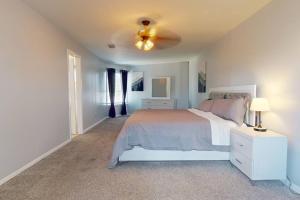 a bedroom with a bed and a ceiling fan at Entire 3/2.5 Lux Retreat Home in the heart of Houston few Miles from Major Houston attractions & Pets Friendly in Houston