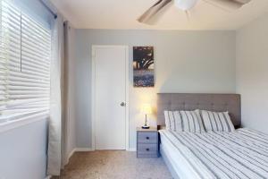 a bedroom with a bed and a lamp on a night stand at Entire 3/2.5 Lux Retreat Home in the heart of Houston few Miles from Major Houston attractions & Pets Friendly in Houston