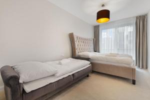 a bedroom with two beds and a window at LAM Jegeho Alej w Jacuzzi & Free Parking in Bratislava