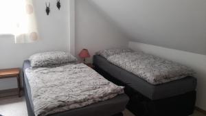 Un pat sau paturi într-o cameră la Neimann