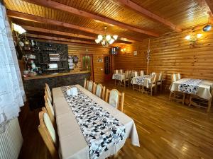 a dining room with a table with wine bottles on it at Guest House Sofia in Bukovel