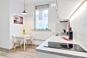 a kitchen with a sink and a table at DeLux9 in Łódź
