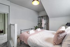 a white bedroom with a bed and a lamp at Deluxe Large Three Room Apartment by Southend Stays in Southend-on-Sea