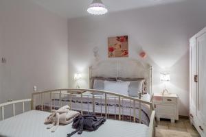 a bedroom with a bed with a white crib at Holiday Home Inga with free private parking in Rijeka