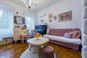 a living room with a couch and a table at Holiday Home Inga with free private parking in Rijeka