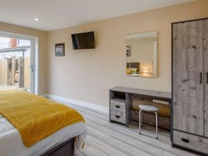 a bedroom with a bed and a dresser and a mirror at 2 bed property in Hornsea 85723 in Hornsea