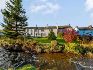 a house next to a body of water at 3 Bed in Caldbeck 86087 in Caldbeck