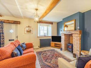 a living room with a couch and a fireplace at 3 Bed in Cockermouth 85717 in Bridekirk