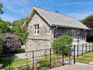 a stone cottage with a black fence at 4 Bed in Ullswater 88023 in Dockray