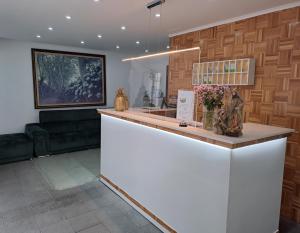 a white counter in a room with flowers on it at Hotel São Miguel in Ponta Delgada