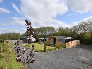 a garden with a wooden cabin in the background at 1 Bed in Llandrindod Wells 88204 in Llandegley