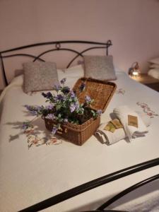 a basket of flowers sitting on top of a bed at MARY HOUSE @ in Sondrio