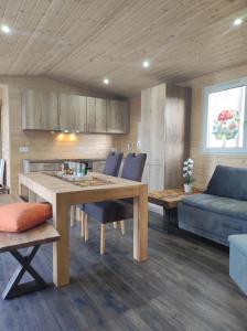 a kitchen and living room with a table and a couch at Unser Großer - Tiny House 