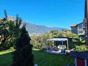 a garden with a gazebo in a yard at MARY HOUSE @ in Sondrio