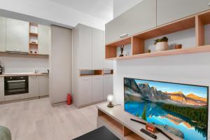 a kitchen with a large flat screen tv on a wall at Studio 1 in Bucharest